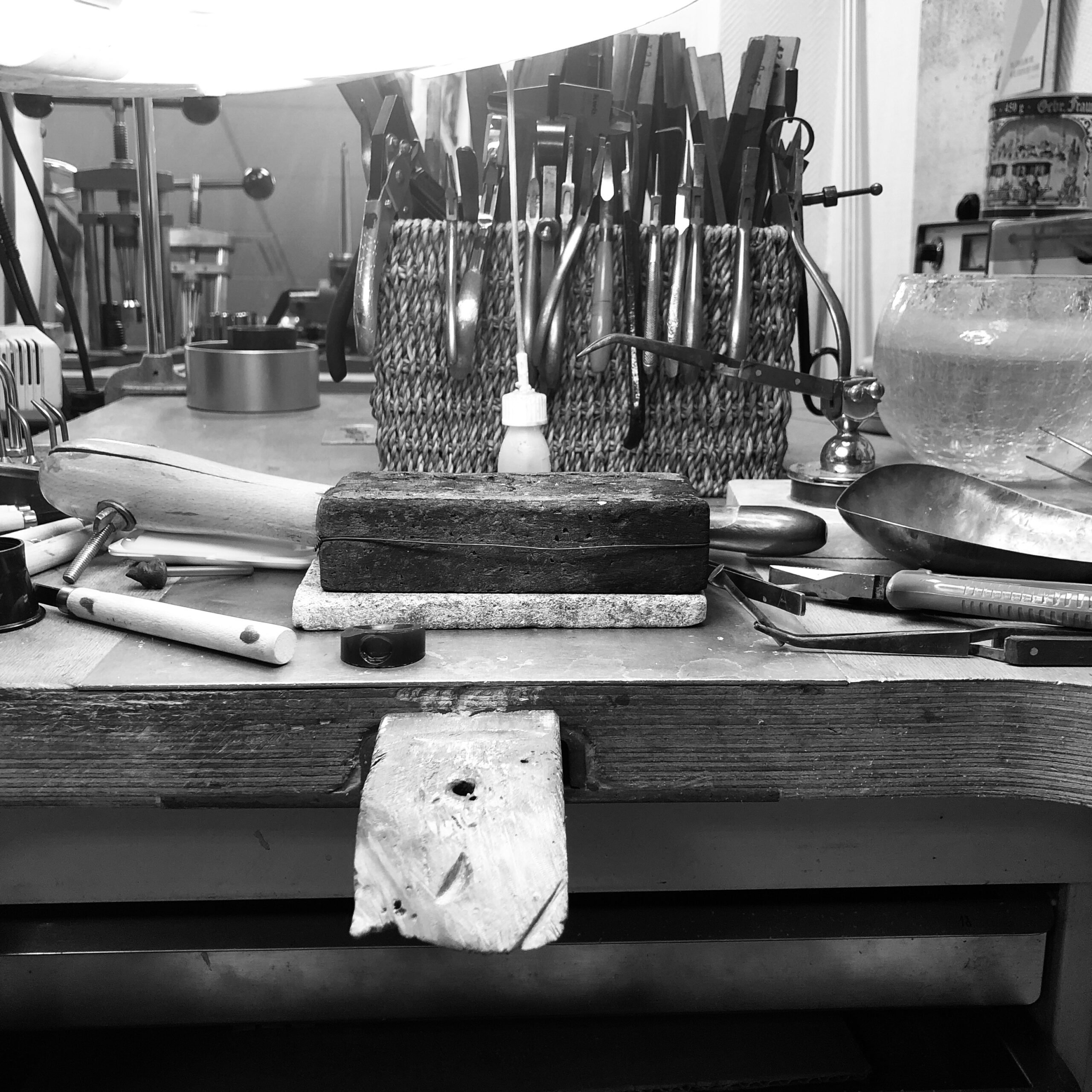 Ein Werkbrett mit verschiedenen Werkzeugen, wie sie in einer Goldschmiede üblich sind.